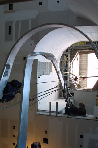 Shop fabricated upper flight stringers rigging into position